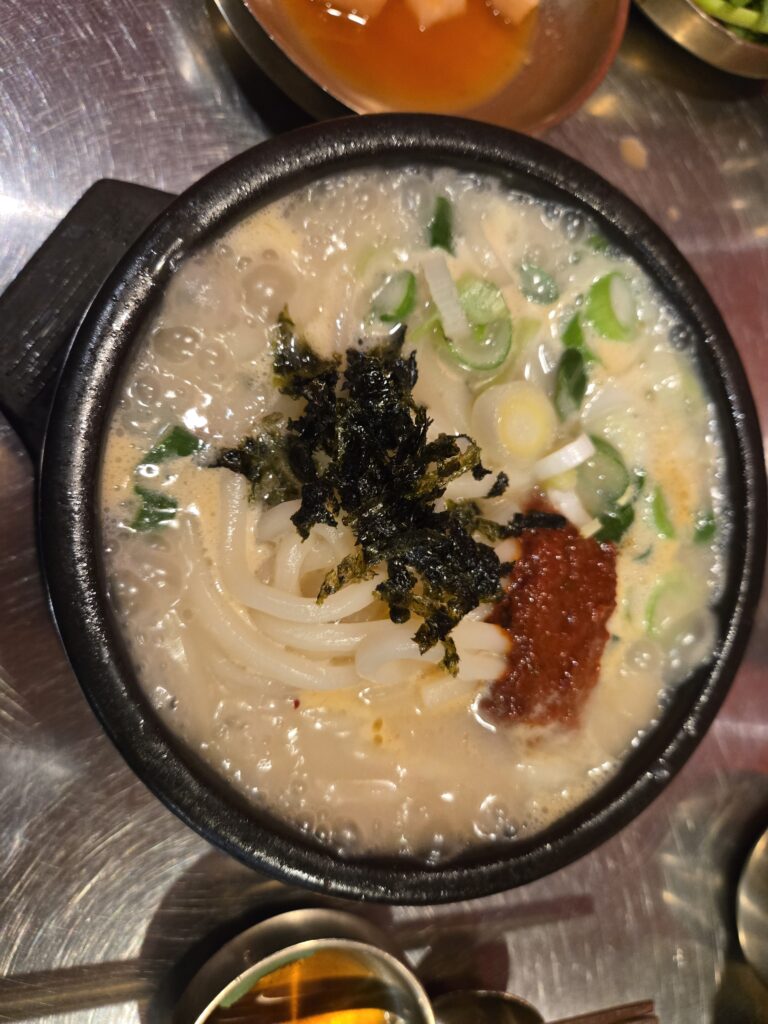 Eolkeun Pork Udon with spicy broth and tender pork slices at Subyeon Saego Pork Rice Soup Seomyeon.